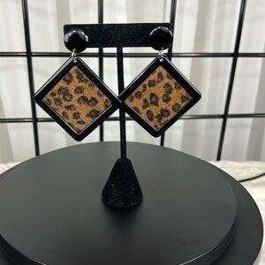 Leopard print earrings in black lacquer box.